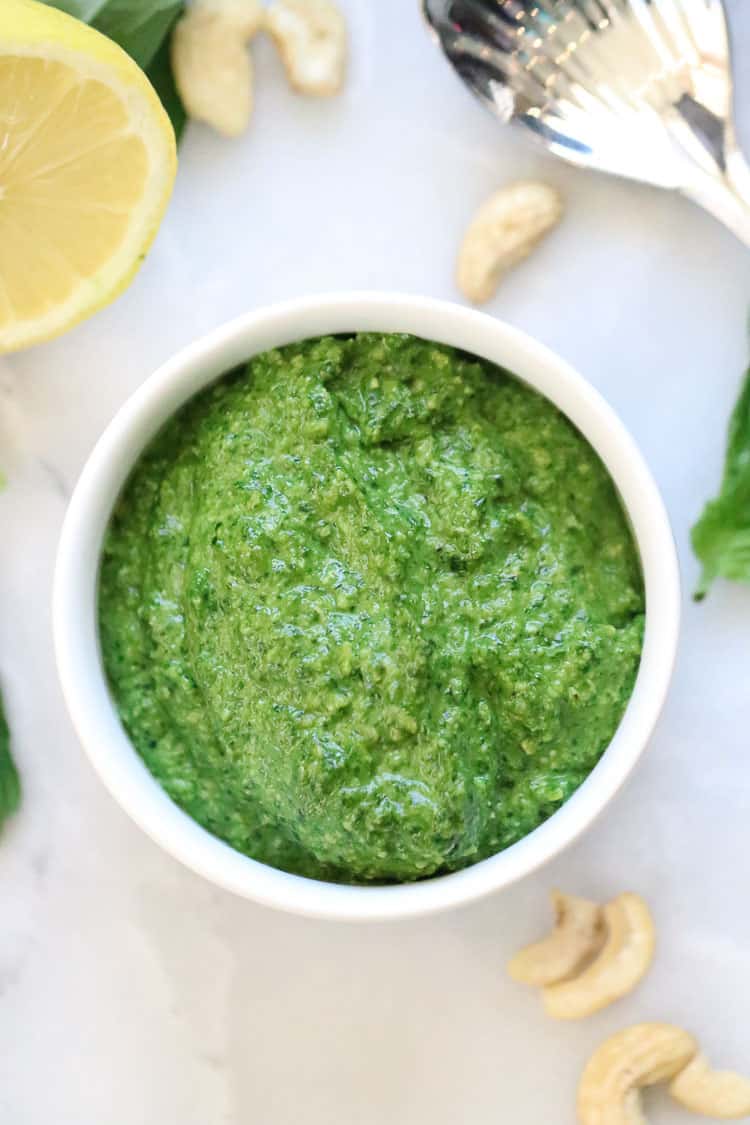 Vegan spinach pesto in white bowl.