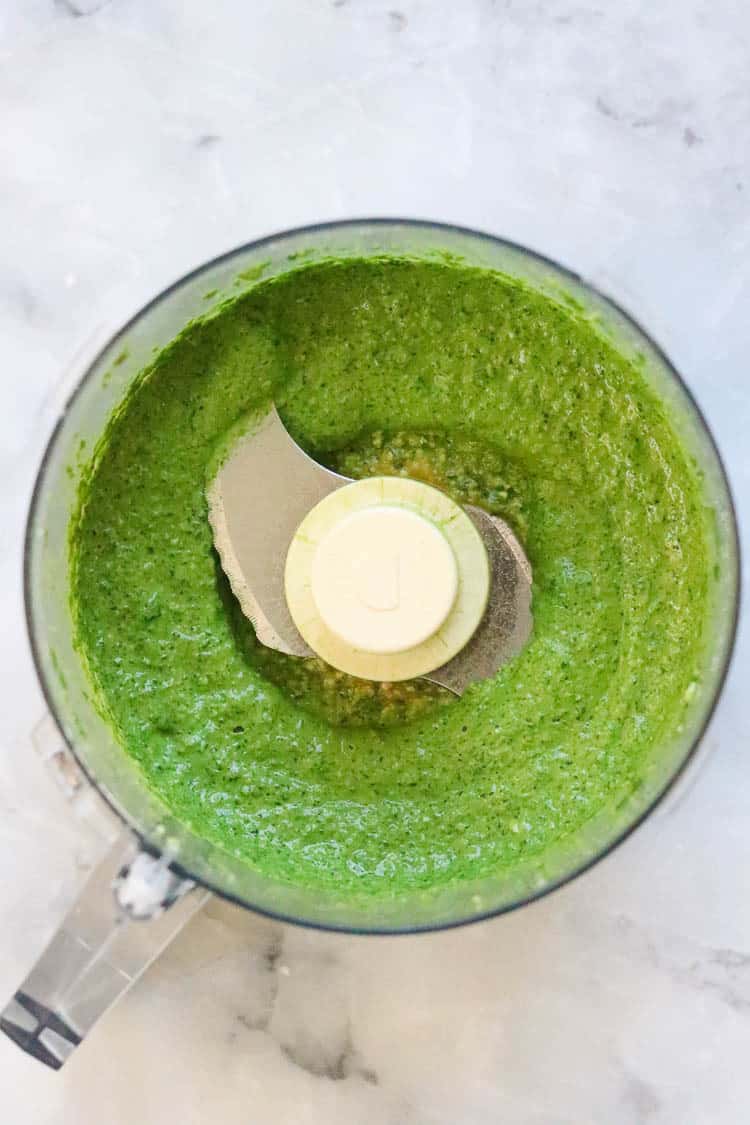 Vegan spinach cashew pesto in a food processor.