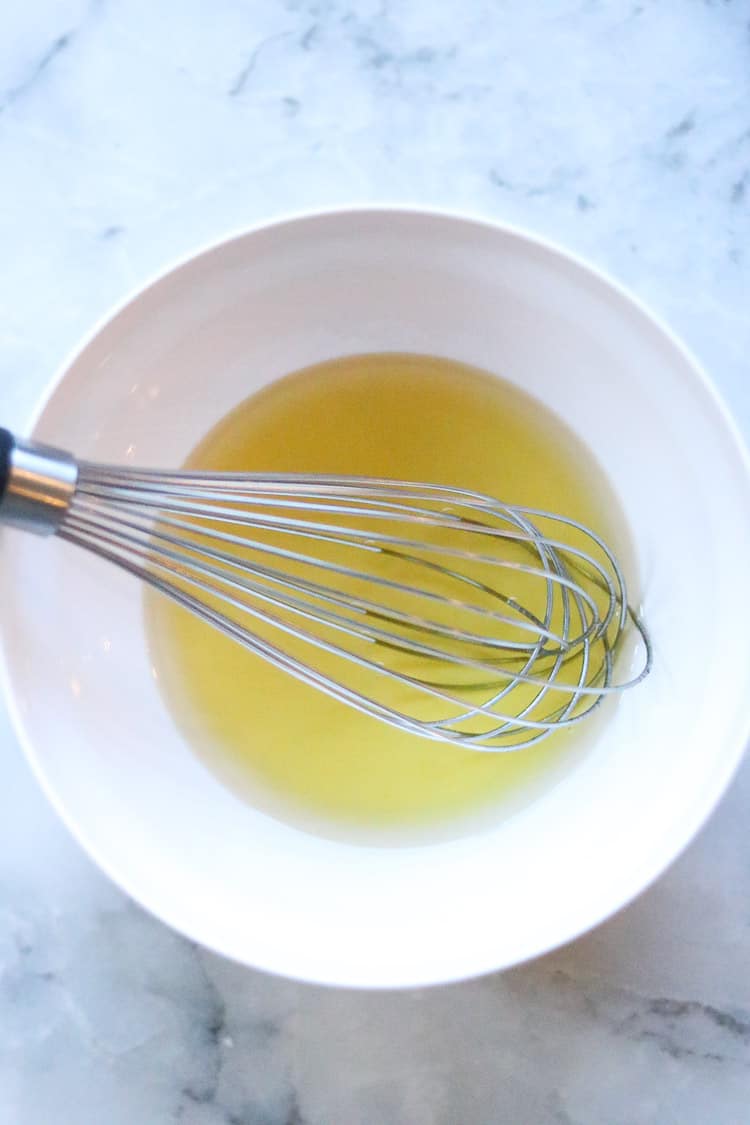 overhead shot of agave and oil mixed to pour over vegan granola