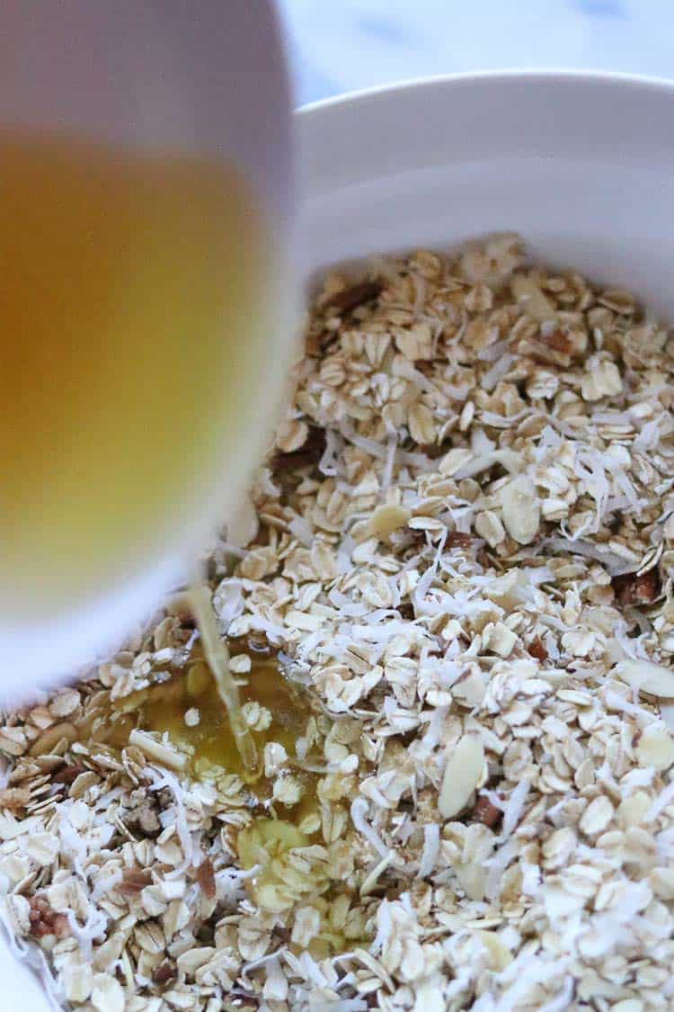 agave and oil being poured onto vegan granola