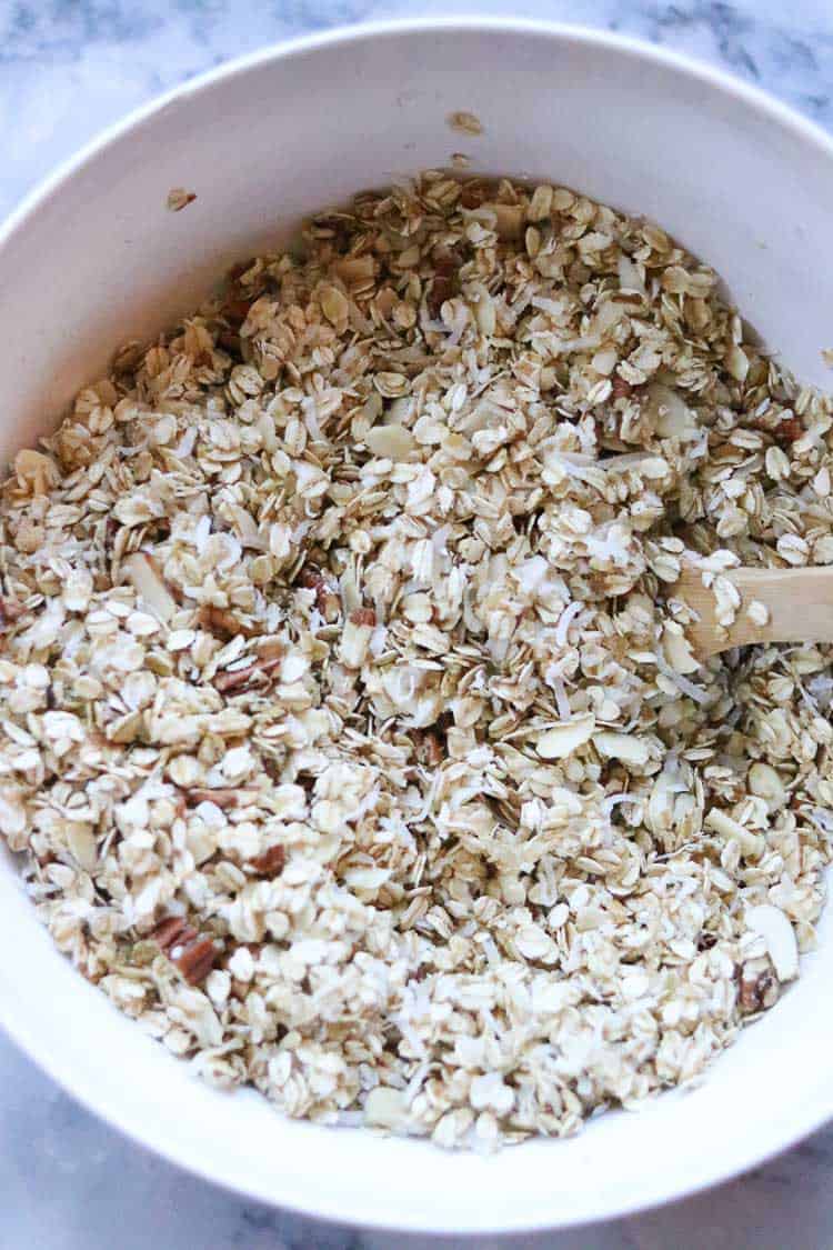 overhead shot of vegan granola mixed with oil and sweetener