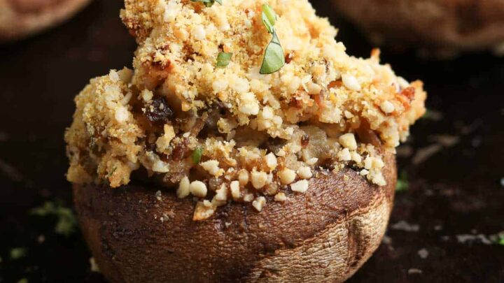 side overhead photo of stuffed vegan mushroom with chopped fresh herbs