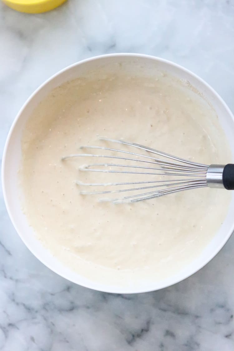 vegan pancake batter with a wire whisk in the bowl 