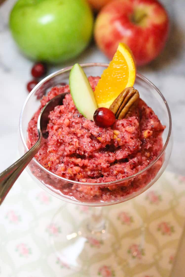fresh cranberry relish in a fancy glass garnished with cranberry and oranges