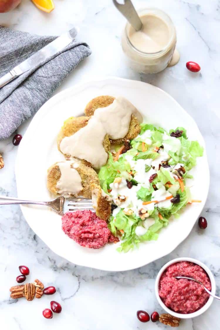 overhead shot of vegan seitan steaks on white plate with cranberry relish