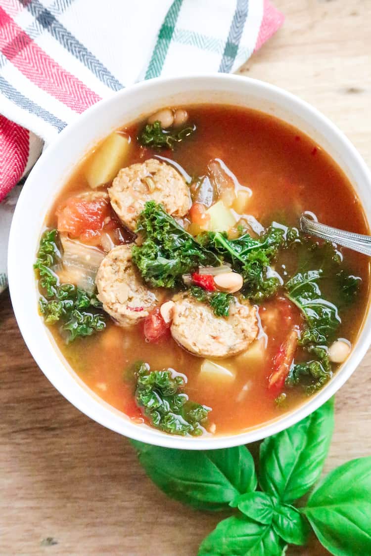 Vegan Italian Sausage soup with Kale and White Beans in a bowl.
