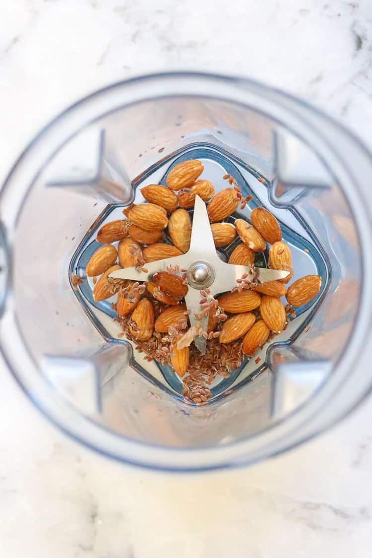 overhead shot of almonds, flaxseed, and water in blender