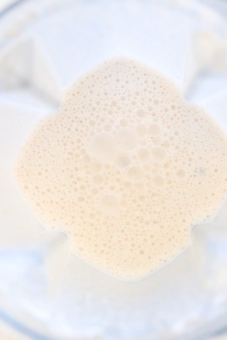 overhead shot of almond and flax seed milk in blender