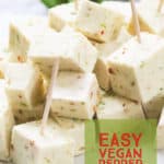 Closeup shot of Vegan pepper jack cheese cut up into little chunks with toothpicks in it.