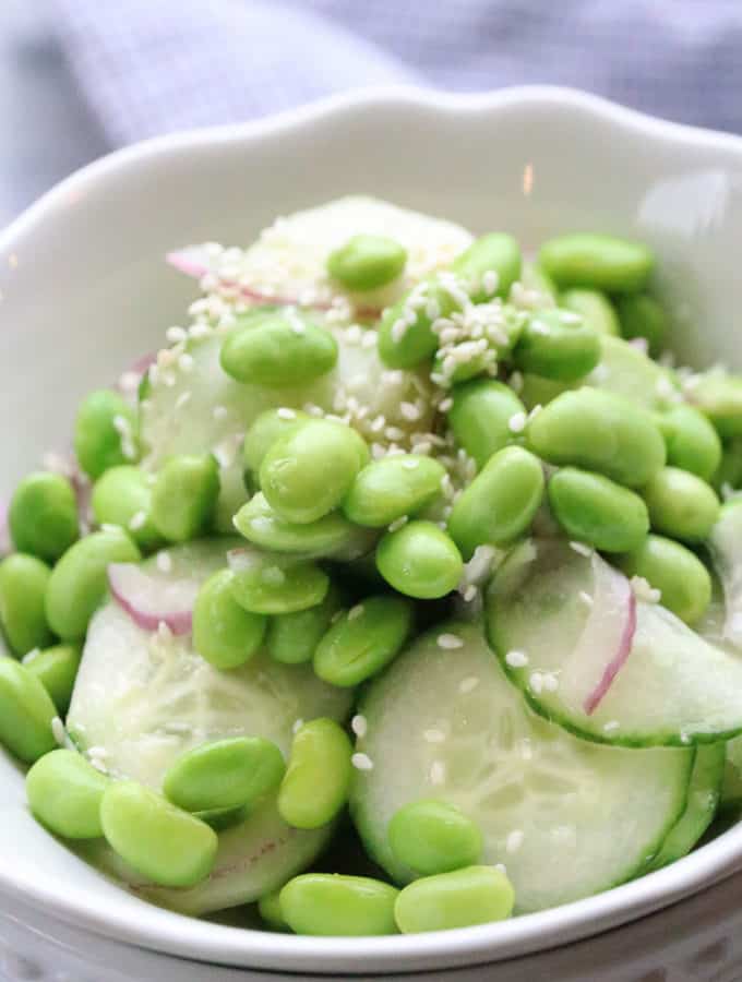 Cucumber Edamame Salad served up in double stacked white bowls.