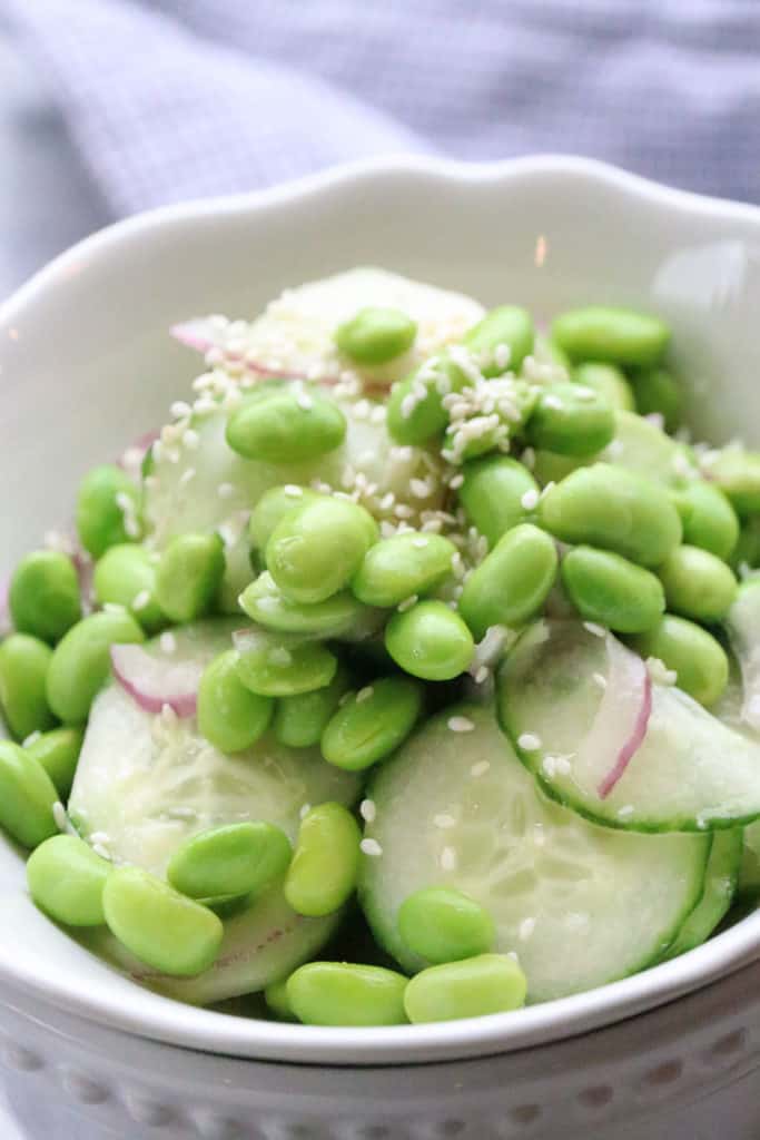 Cucumber Edamame Salad served up in double stacked white bowls.