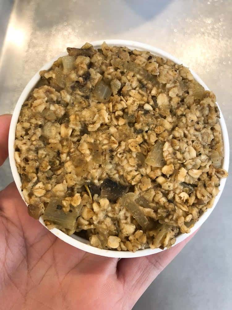 overhead view of vegan oatmeal burger mixture in a white shaping lid