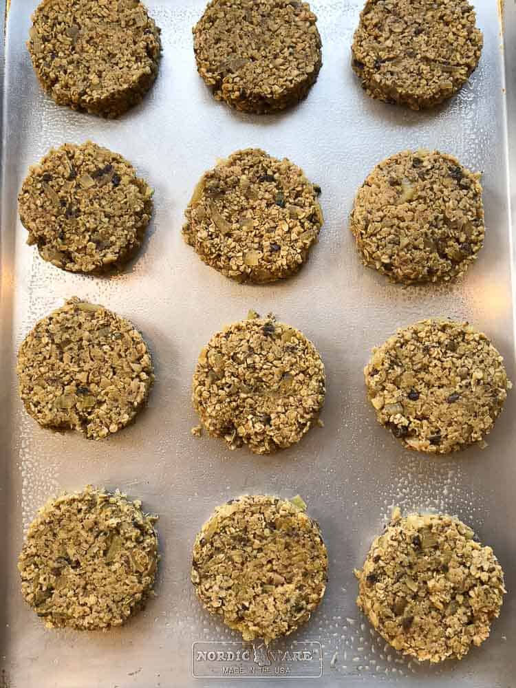 overhead shot of shaped vegan oatmeal burgers on a tray