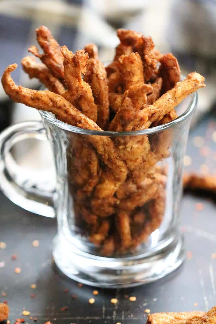 Side view of vegan jerky in a clear glass