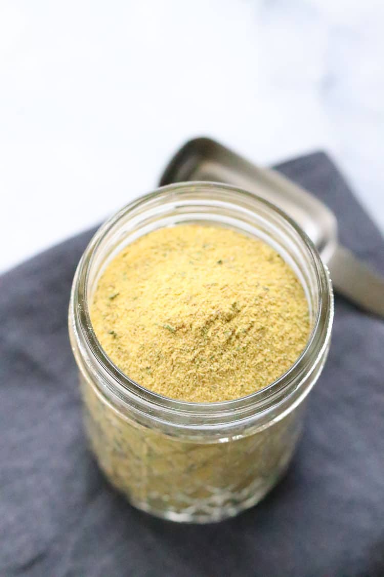 overhead shot of vegan chicken style broth in a small clear jar on a dark gray napkin