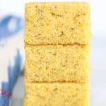 side shot of vertical stack of three squares of cornbread