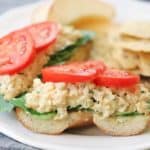 side closeup shot of chickpea salad sandwich with tomato