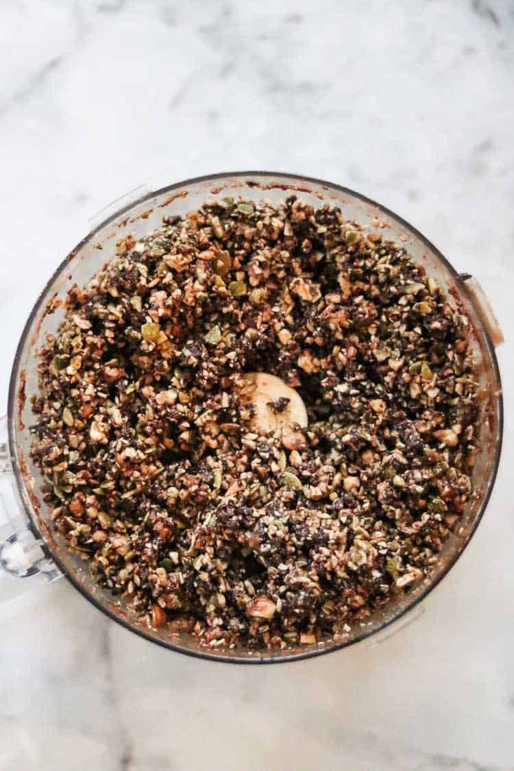 overhead view of chopped mixture for gingersnap bars in food processor bowl