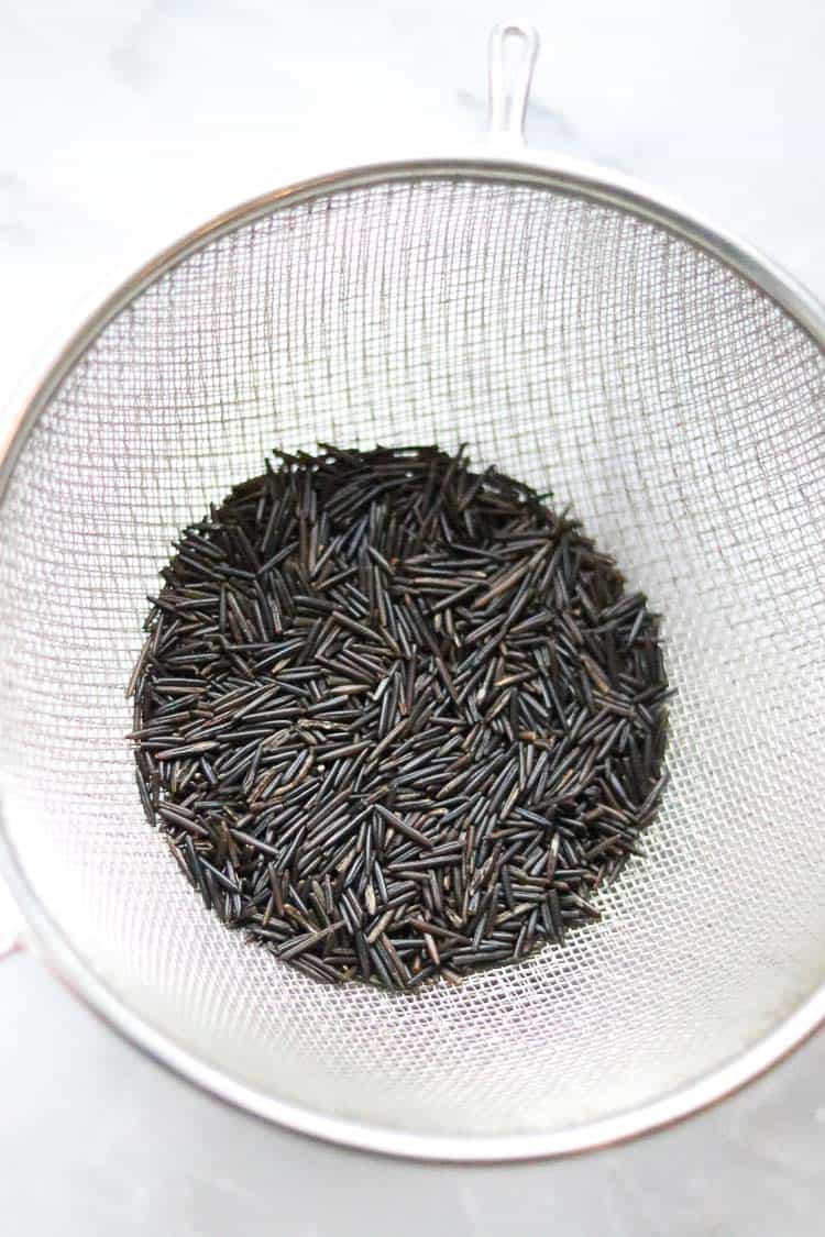 overhead shot of wild rice in a colander 