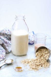 side overhead shot of oat milk in a jug and oats nearby