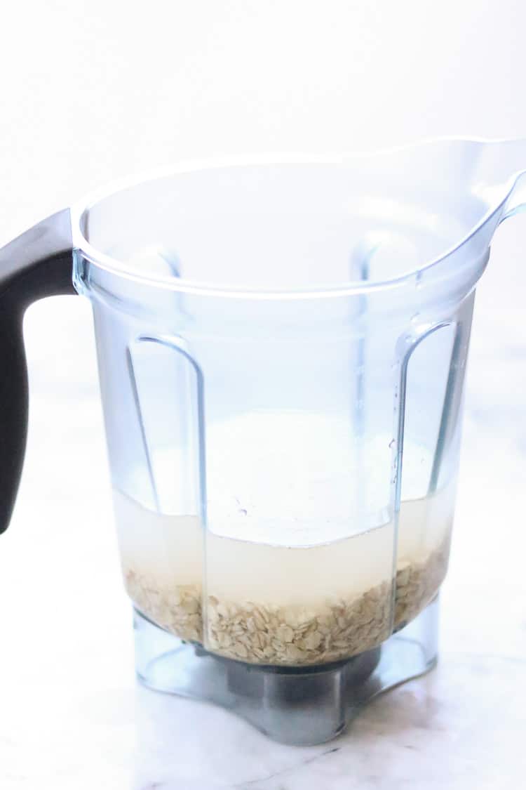 side overhead shot of oats and water in a vitamin blender