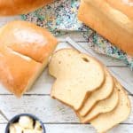 overhead shot of loaves of whole wheat bread with sliced bread and butter