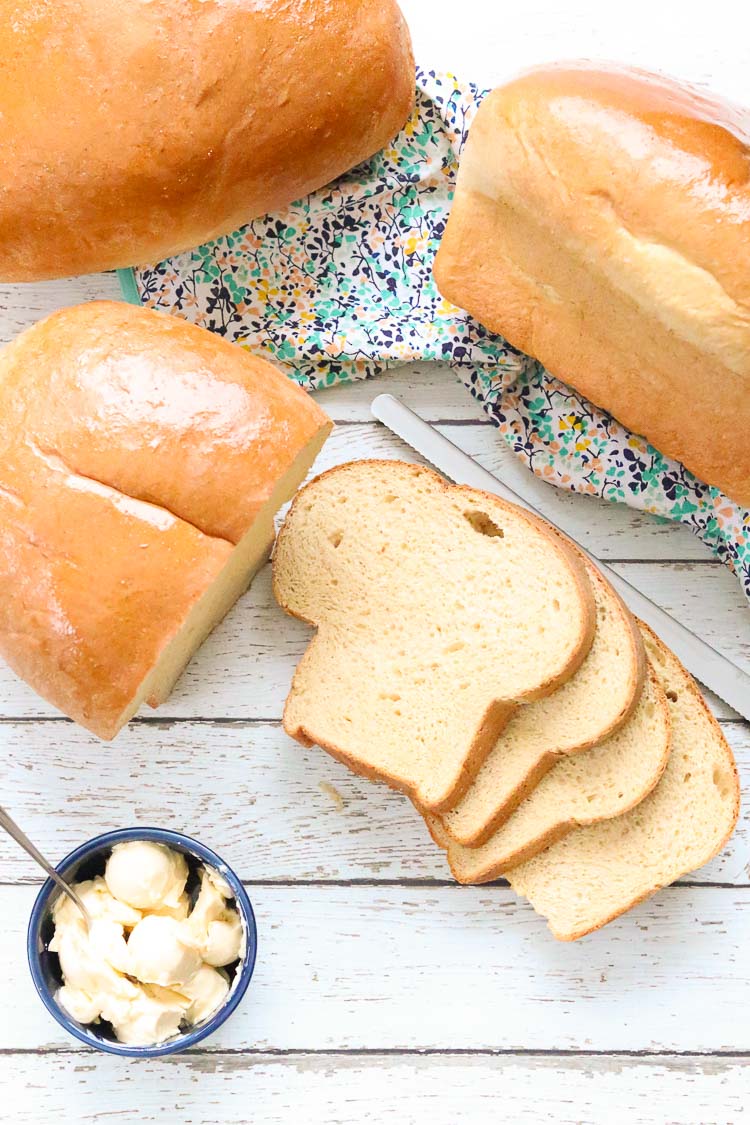 overhead shot of loaves of whole wheat bread with sliced bread and butter