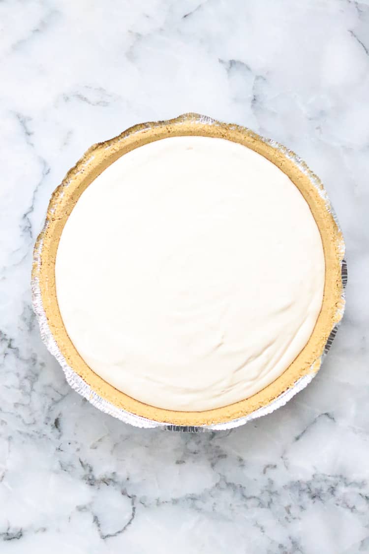 unbaked vegan cheesecake in a graham cracker pie crust ready to bake