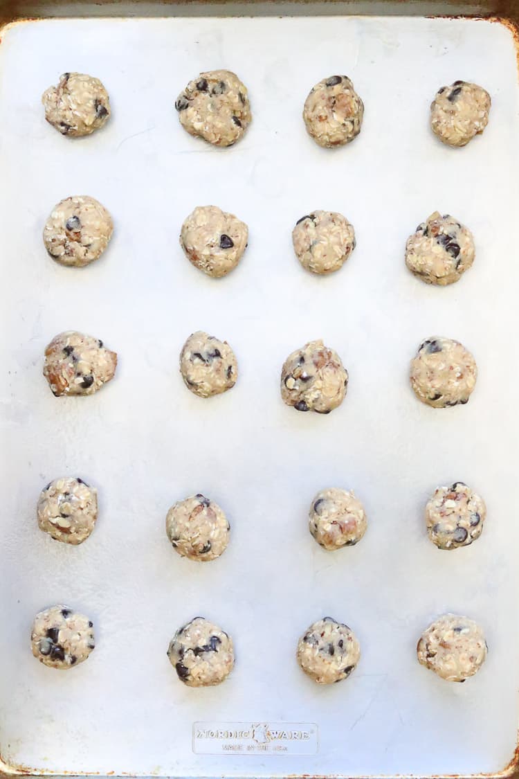 overhead shot of cookie dough batter in ball shape on baking tray