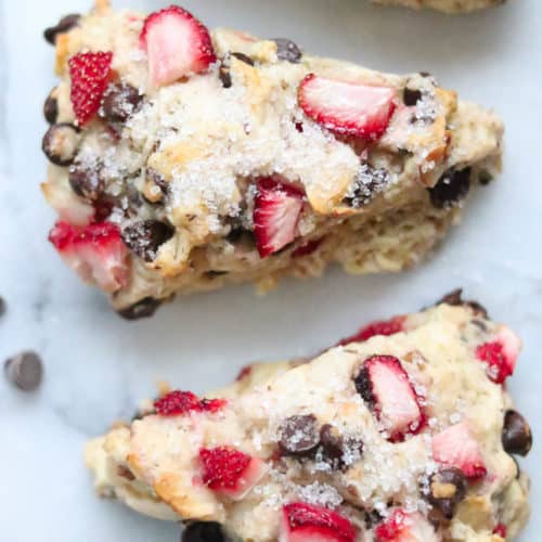 overhead closeup shot of vegan scones with strawberries and chocolate chips