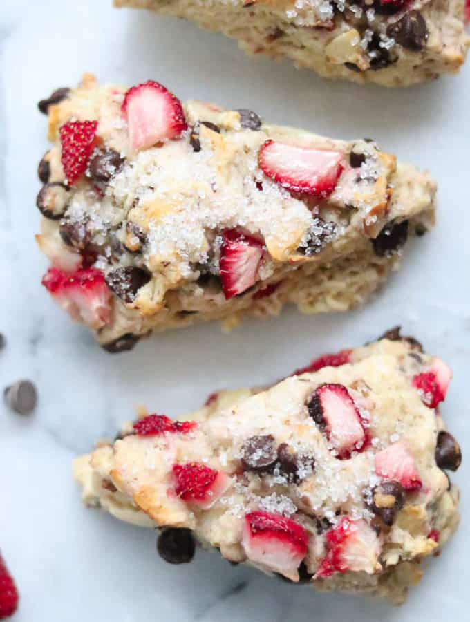 overhead closeup shot of vegan scones with strawberries and chocolate chips