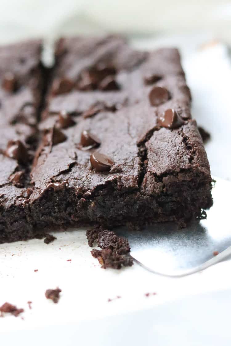 Close up of fudgy brownie being served.