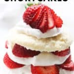 Pinnable image of strawberry shortcake biscuit layered with coconut whip cream.
