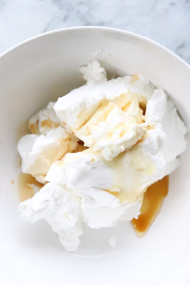 overhead shot of vegan coconut cream in a white bowl with vanilla and agave