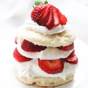 Layered strawberry shortcake with coconut whipped cream.