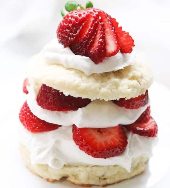 Layered strawberry shortcake with coconut whipped cream.