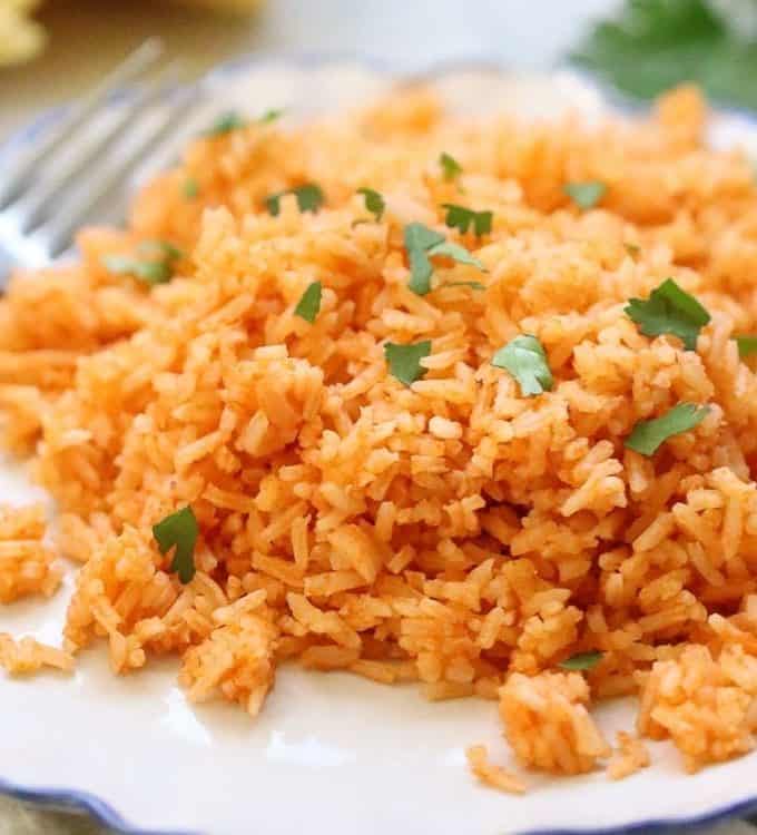 fluffy vegan Mexican rice on a plate with cilantro garnish