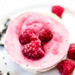 overhead closeup shot of vegan ice cream cup with raspberries on top
