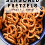 overhead photo of seasoned pretzels in a blue bowl with text overlay for pinterest