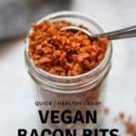 overhead shot of vegan bacon bits in a jar on a marble background with text overlay for pinterest