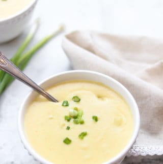 overhead shot of vegan creamy potato soup with scallions on top