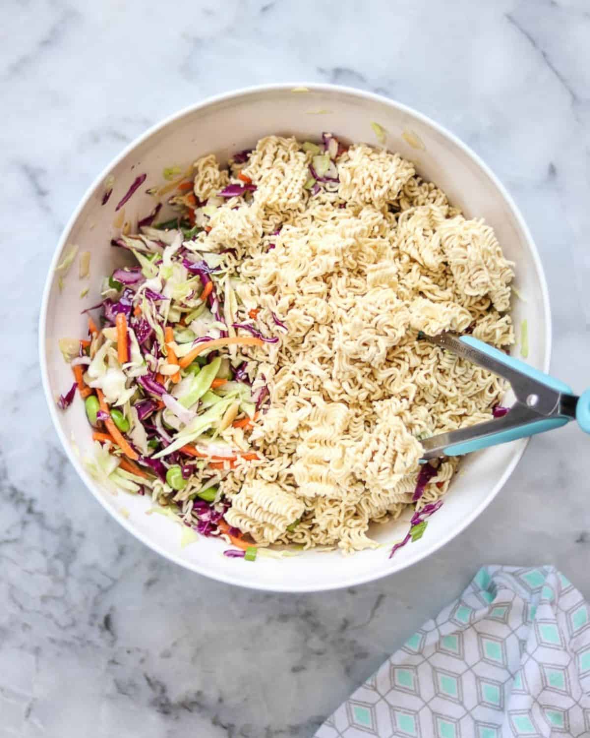 Crunchy ramen noodles and cabbage salad ingredients in a bowl.