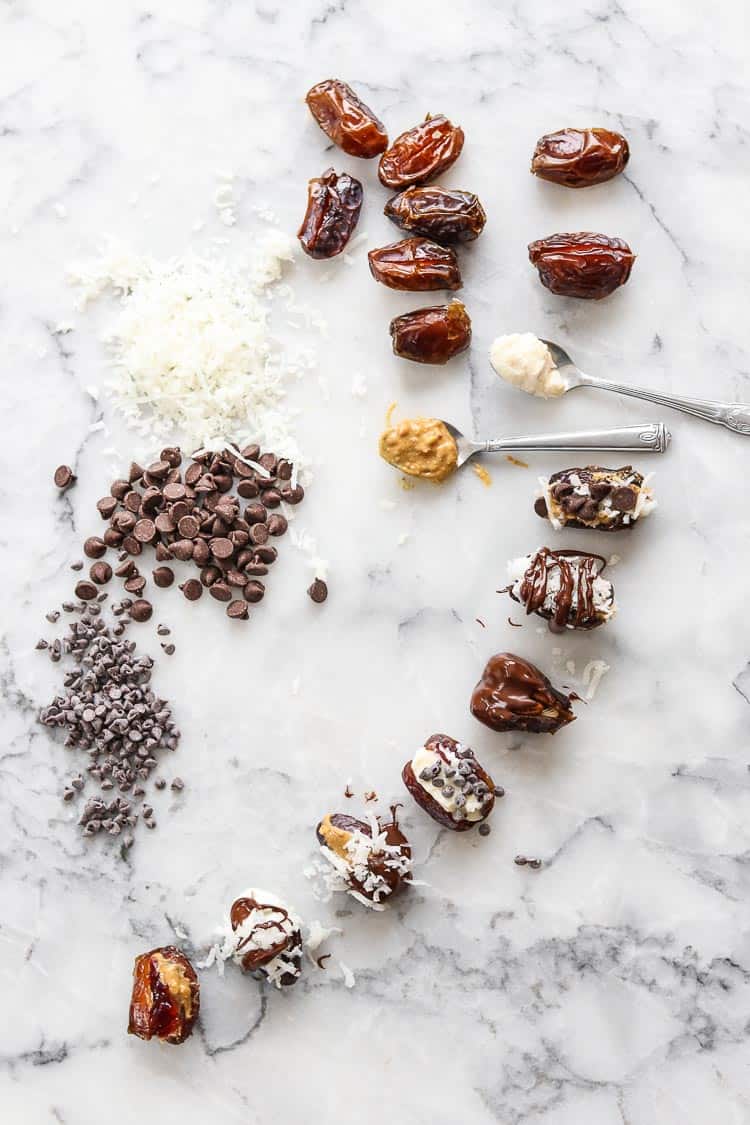 wide overhead shot of dates and toppings such as shredded coconut, chocolate, peanut butter