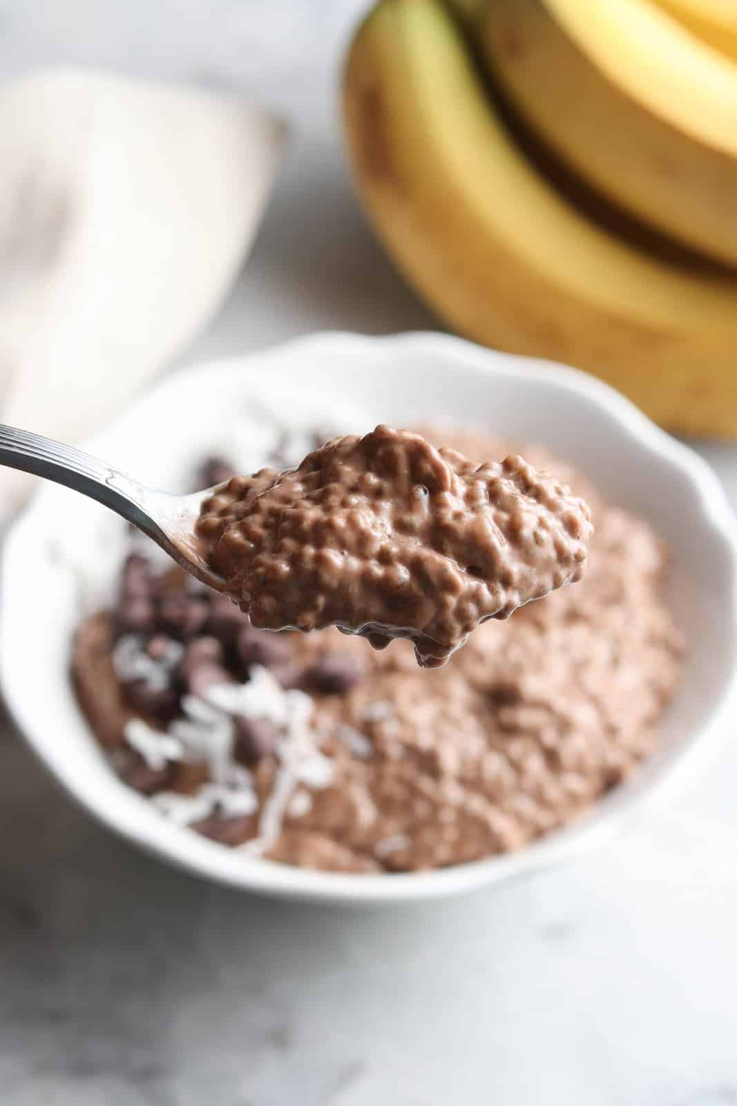 A scoop of chocolate chia seed pudding on a spoon