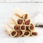 side overhead shot of ends of taquitos stacked in a pyramid shape