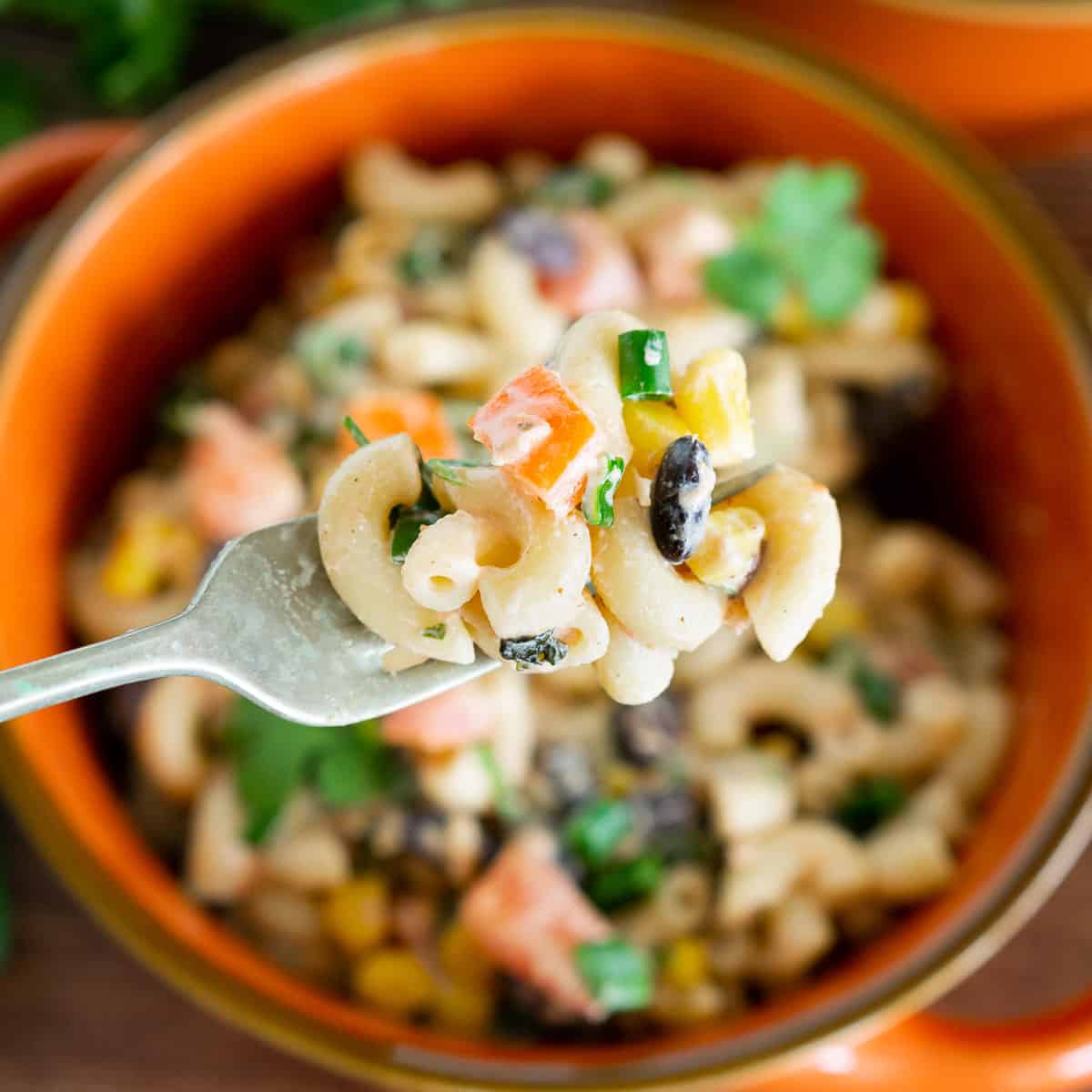 Mexican pasta salad with salsa on a fork