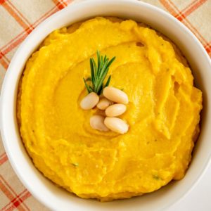 mashed butternut squash with white beans in a white bowl