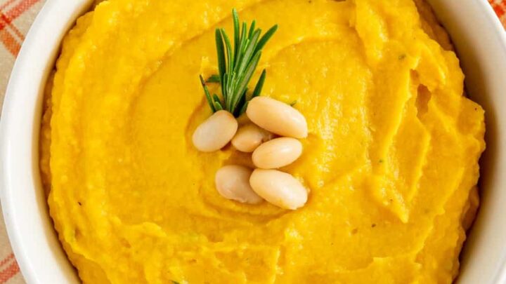 mashed butternut squash with white beans in a white bowl
