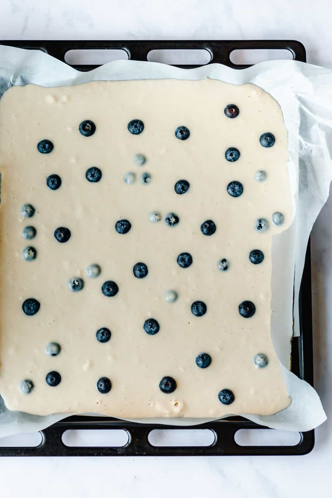 vegan pancake batter in a baking sheet ready to bake