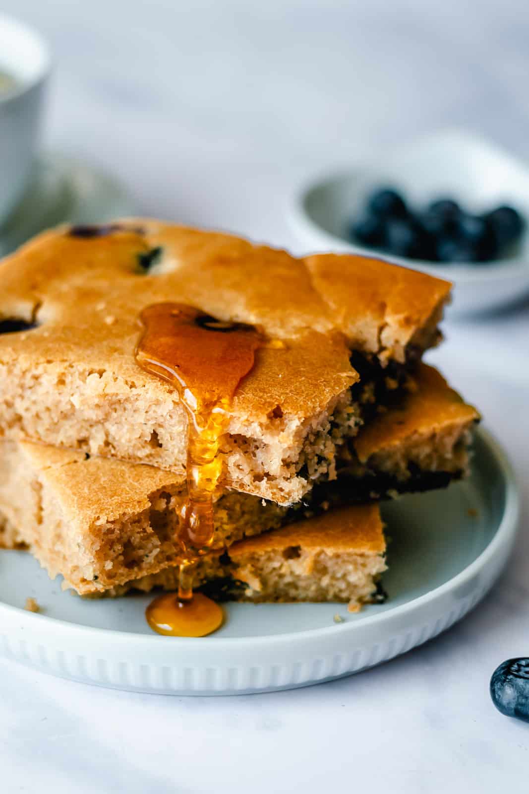 stack of blueberry sheet pan pancakes with syrup